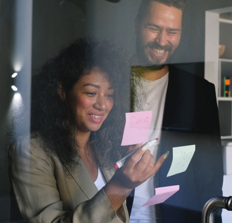 Woman and Man laughing at sticky notes