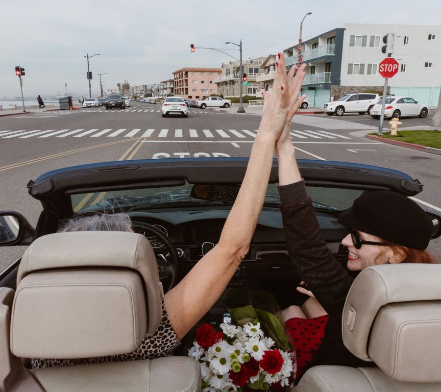 Two Women Celebrating in a Car